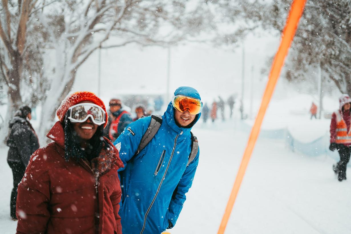 couple wearing ski goggles in the snow